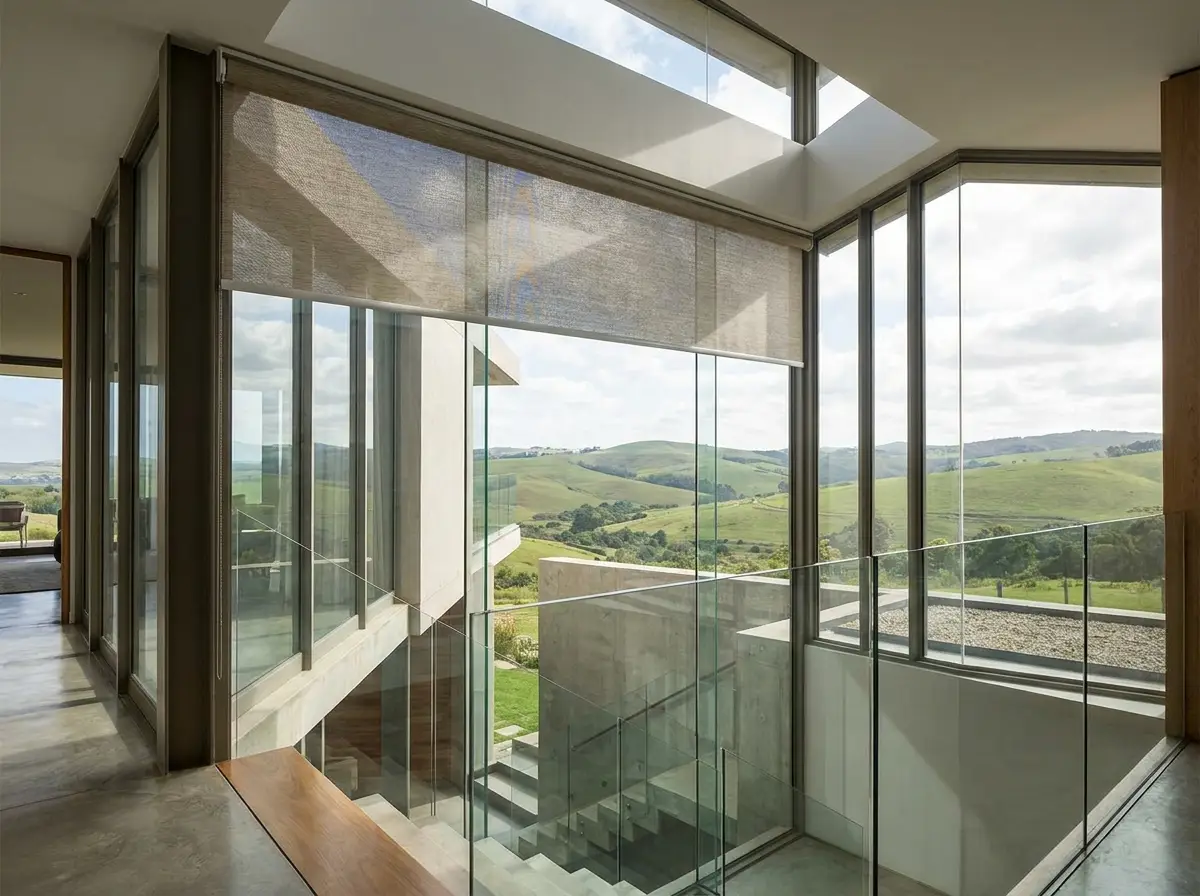 Motorised blind covering the high clerestory glass above a Welgemoed stair landing, driven from a switch on the floor below